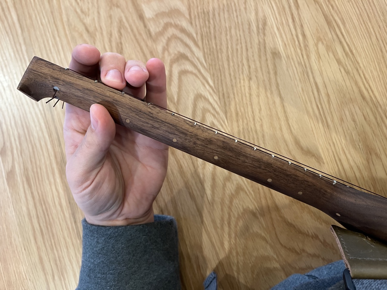 Nicole's ukulele's neck, viewed from above while playing